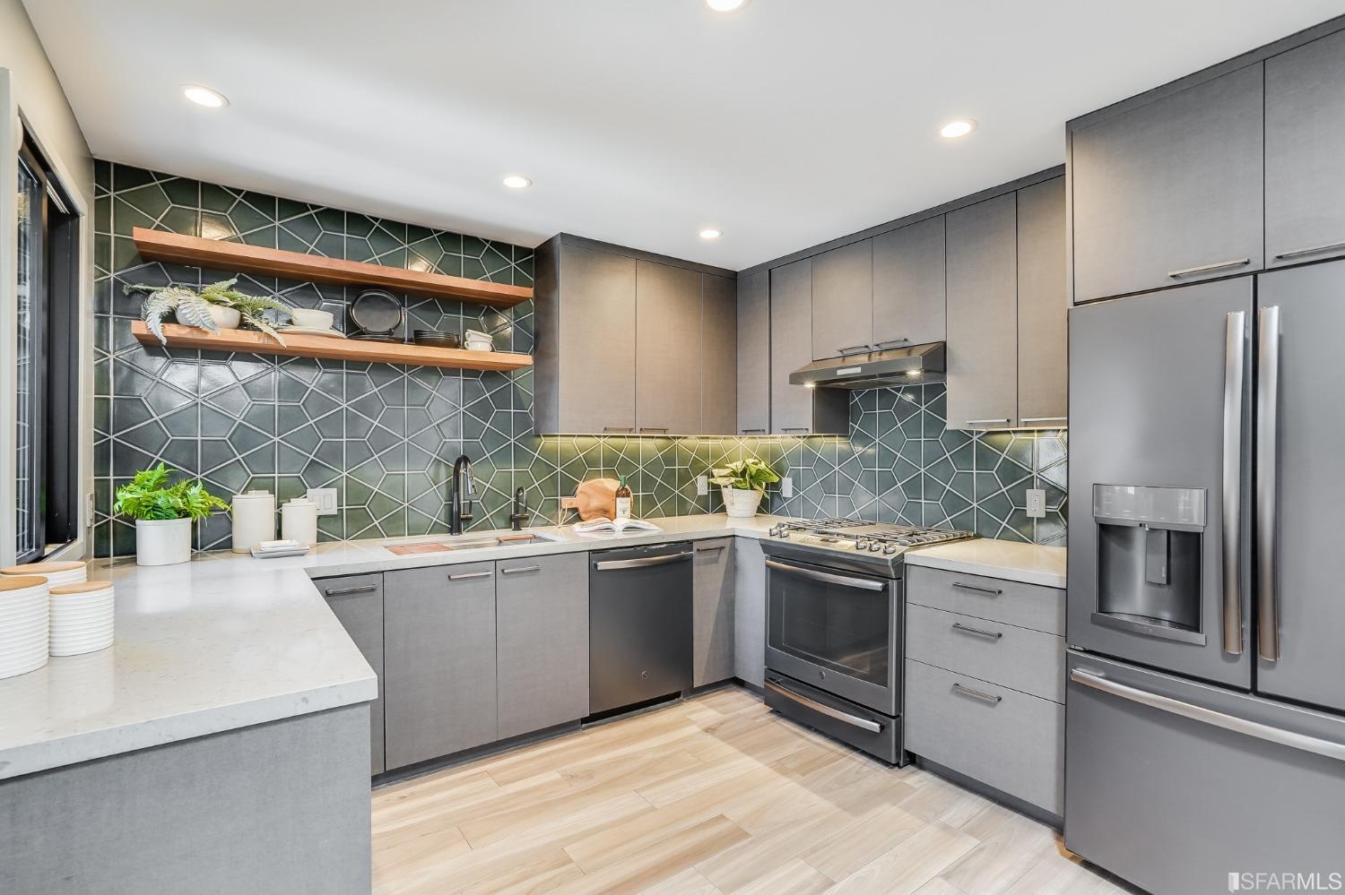 91 Bronte Street San Francisco, CA 94110 - Photo 5 of 24 a kitchen with stainless steel appliances granite countertop a sink a stove and refrigerator