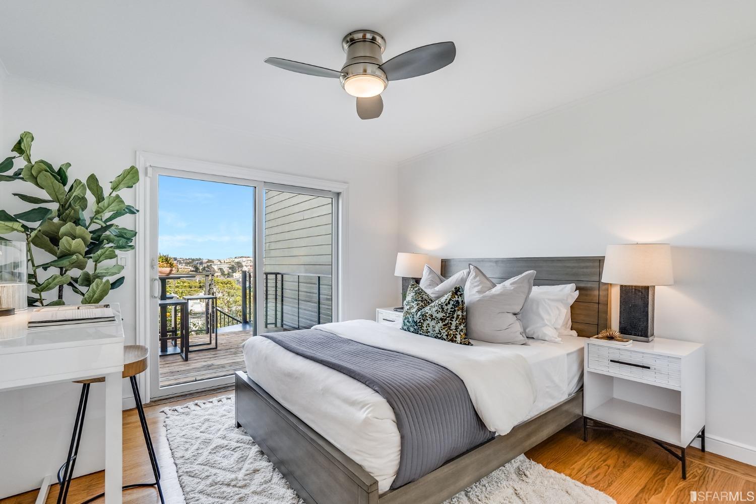 91 Bronte Street San Francisco, CA 94110 - Photo 8 of 24 a bedroom with a bed and a chandelier