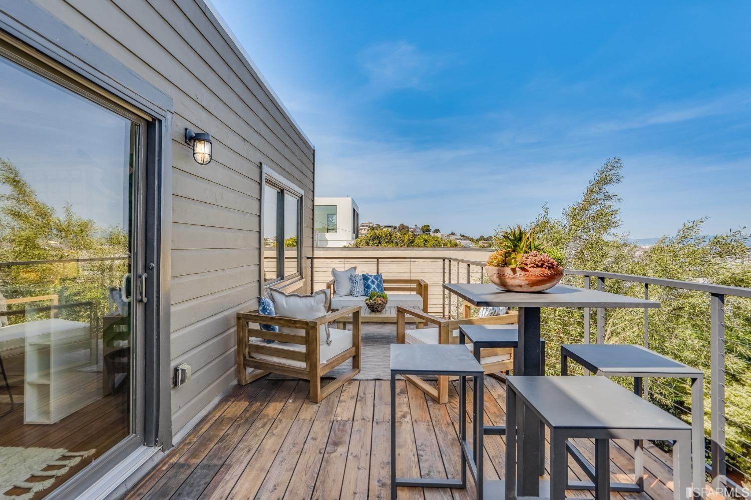 91 Bronte Street San Francisco, CA 94110 - Photo 9 of 24 a view of a balcony with chairs and wooden floor
