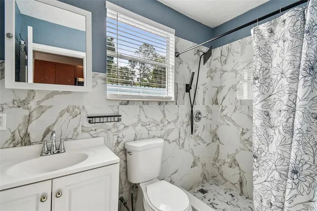 a bathroom with a bathtub and shower