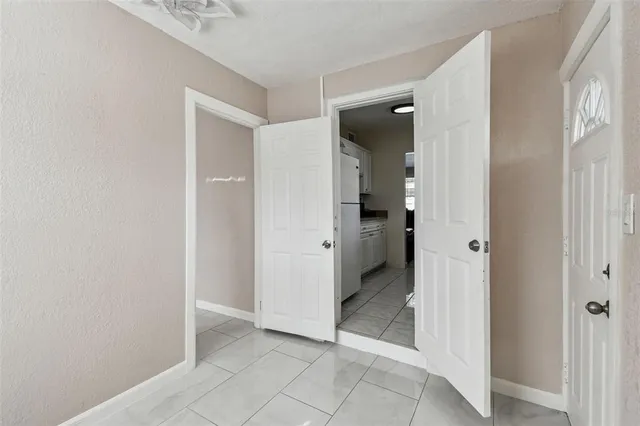 an entryway space and a bathroom with a sink
