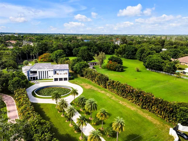 an aerial view of a house with swimming pool and outdoor space