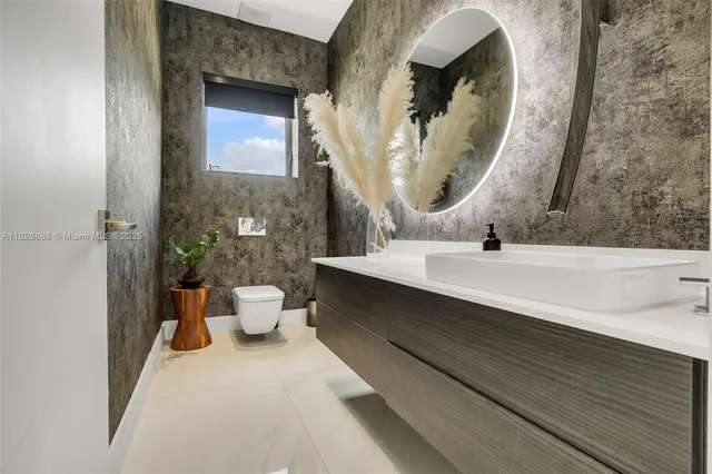 a view of a porch with a floor to ceiling window and potted plants