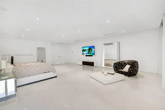 a large bedroom with a large bed and a large window