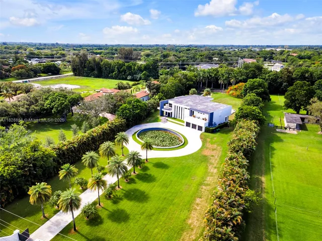 a view of kitchen with stainless steel appliances kitchen island a table and chairs in it