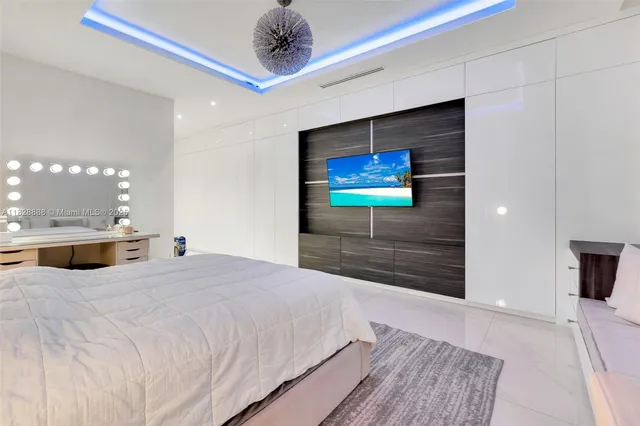 a living room with furniture a floor to ceiling window and a flat screen tv