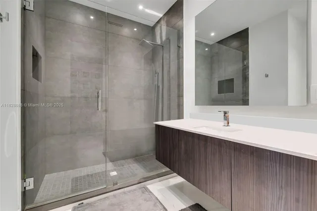 a view of a white house in a big yard with large trees