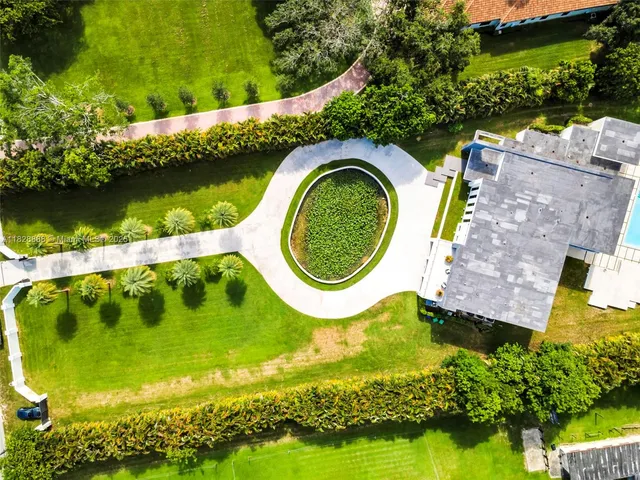 a kitchen with stainless steel appliances kitchen island granite countertop a table and chairs in it