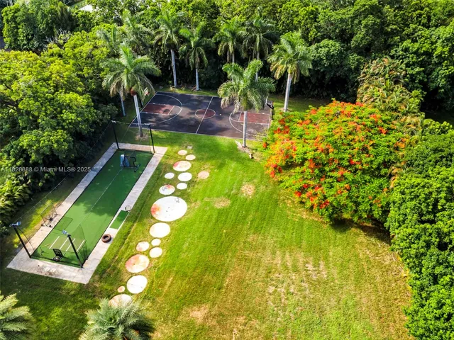 a kitchen with stainless steel appliances kitchen island granite countertop a refrigerator and a sink