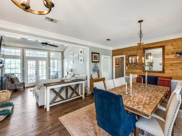 a living room with furniture a rug and a chandelier
