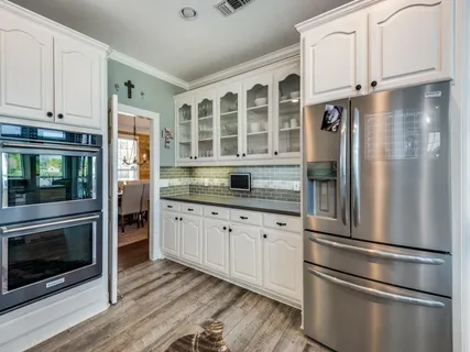 a kitchen with granite countertop stainless steel appliances and wooden cabinets
