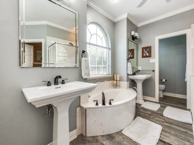 a bathroom with a bathtub a sink and mirror