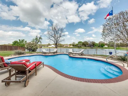 a view of a swimming pool with lounge chair