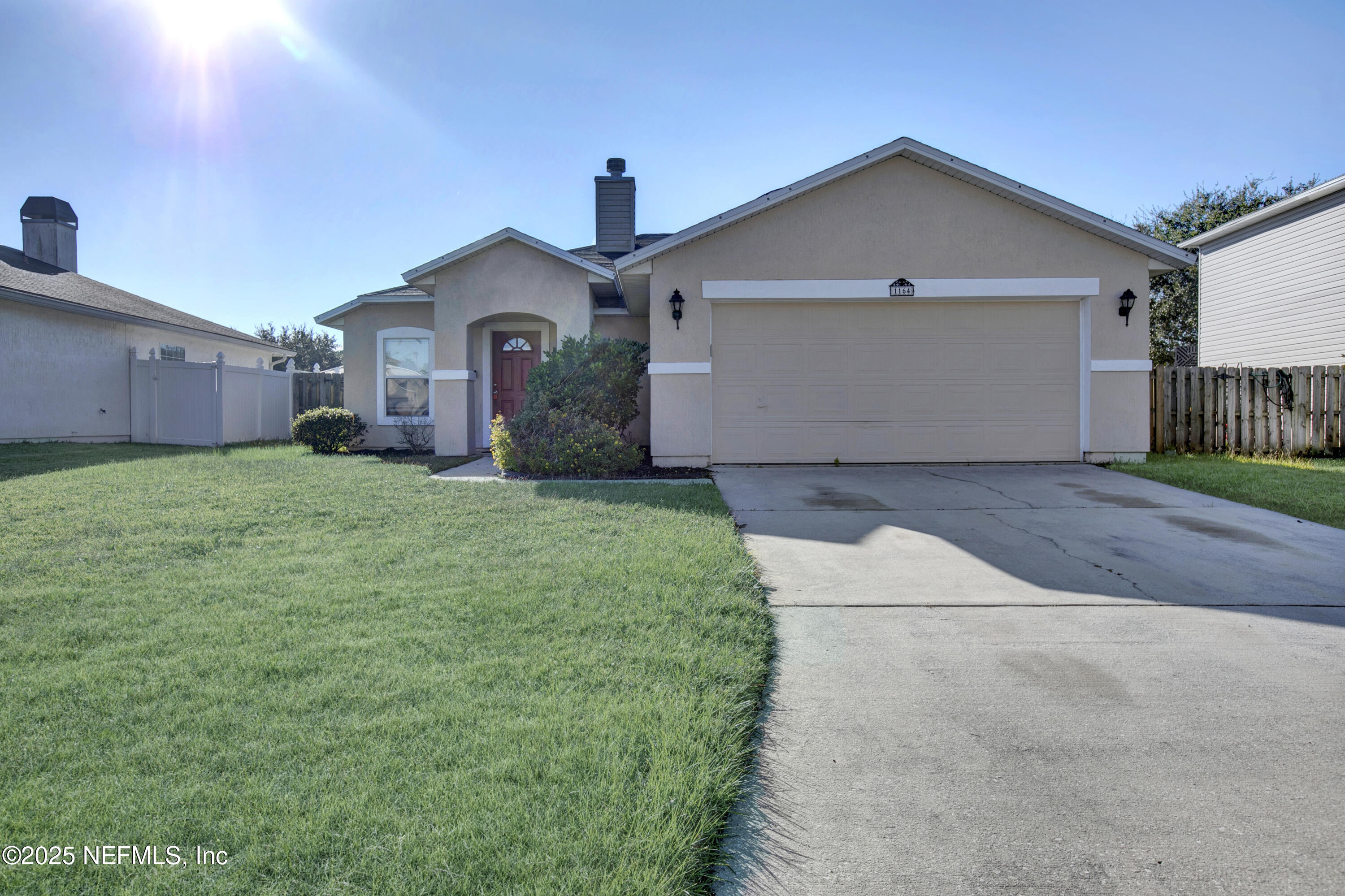 1164 Dawn Light Road Jacksonville, FL 32218 - Photo 19 of 19 a front view of a house with a yard and garage