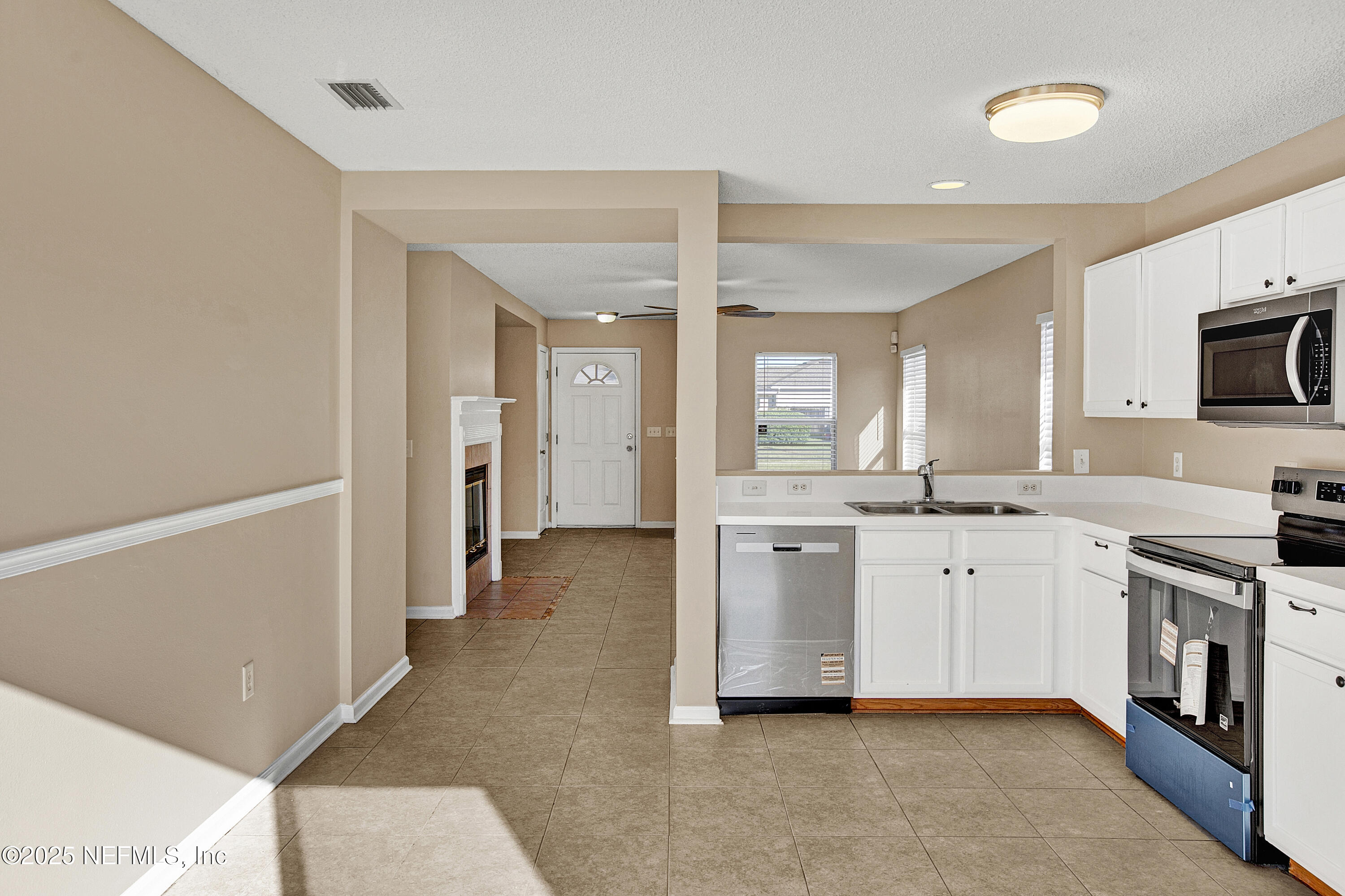 1164 Dawn Light Road Jacksonville, FL 32218 - Photo 6 of 19 a large kitchen with cabinets and stainless steel appliances