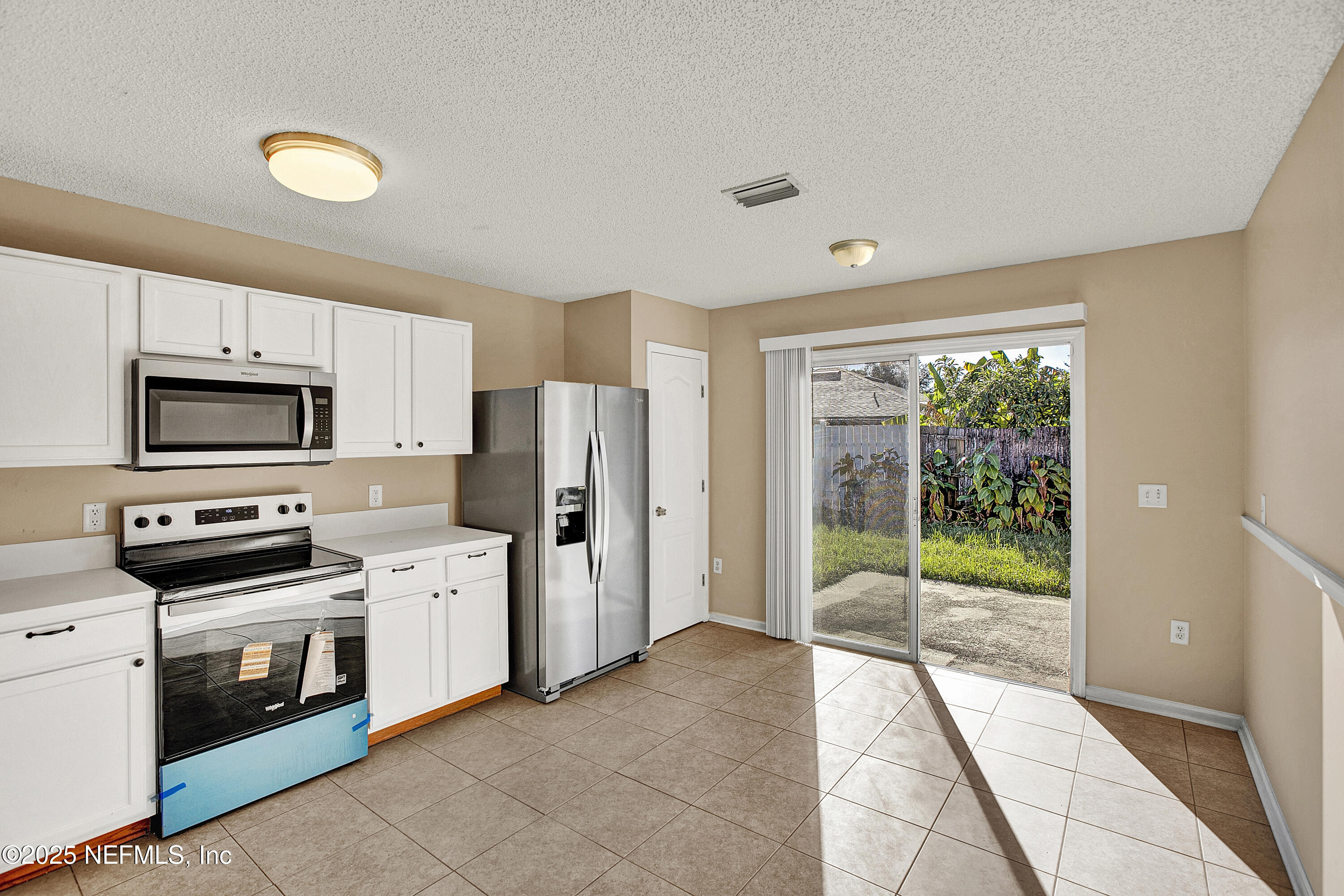 1164 Dawn Light Road Jacksonville, FL 32218 - Photo 7 of 19 a kitchen with stainless steel appliances a refrigerator sink and stove