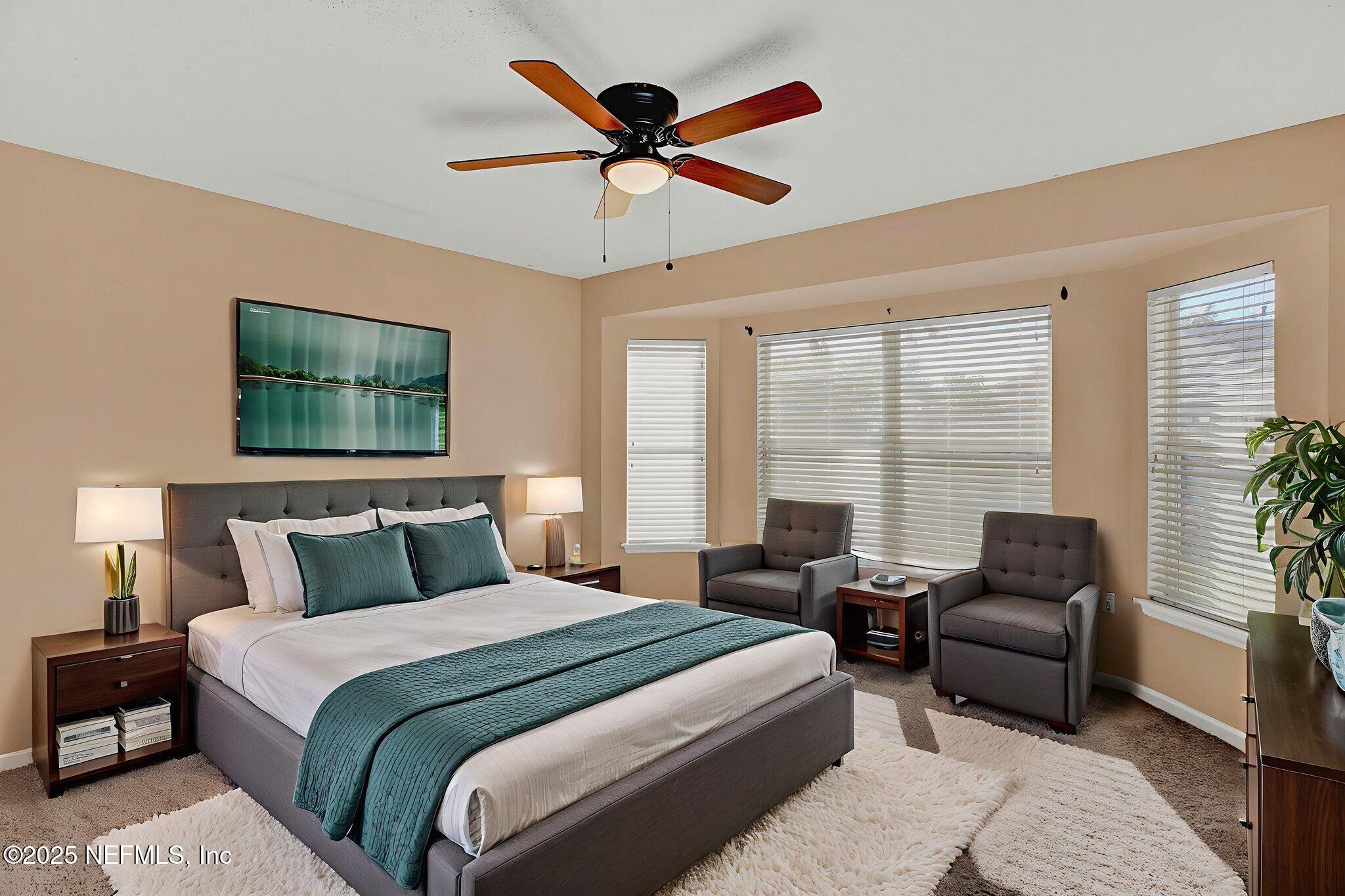 1164 Dawn Light Road Jacksonville, FL 32218 - Photo 9 of 19 a bedroom with a bed a couch and a large window