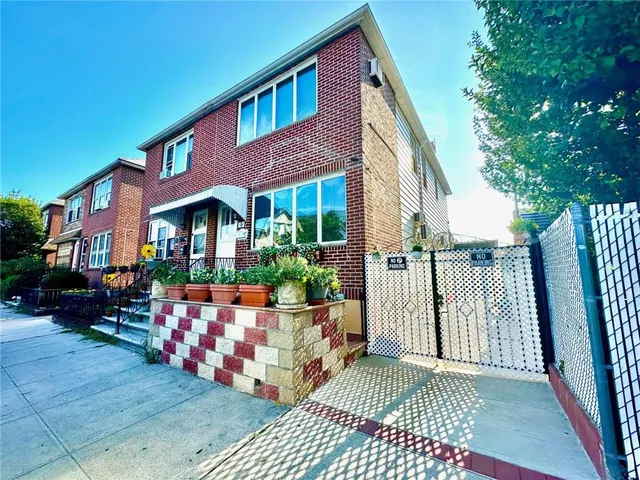 a view of a house with wooden floor and bench in a patio