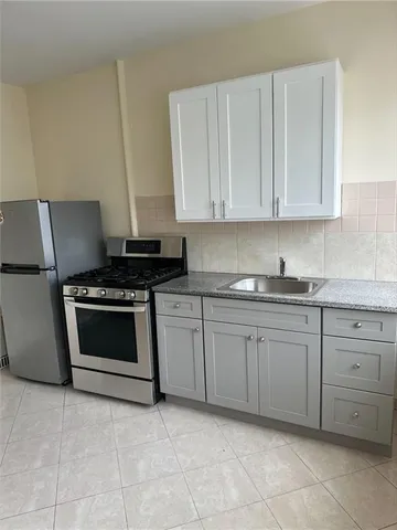 a kitchen with a stove a sink and a refrigerator