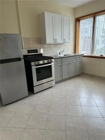 a view of a livingroom with an empty space and a window