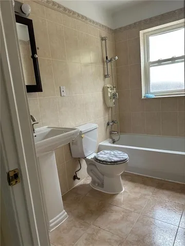 a bathroom with a toilet a sink and a shower