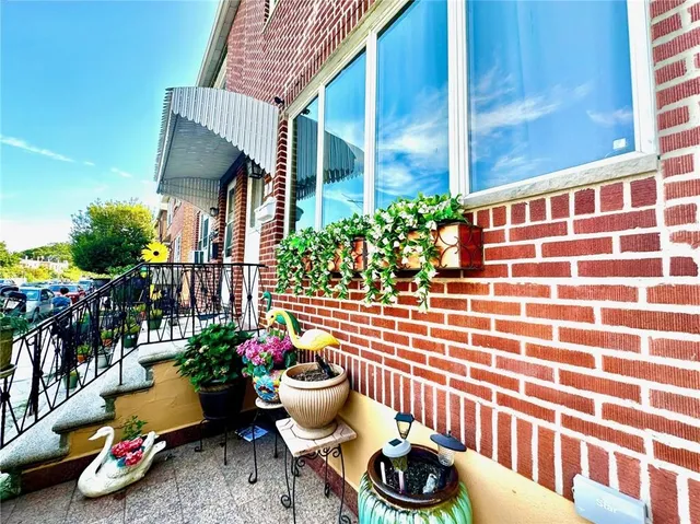 a view of a chairs and table in a patio and a fountain
