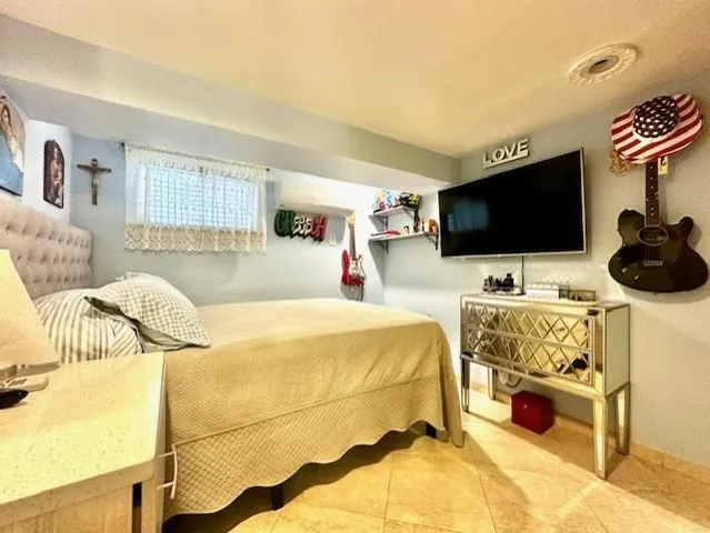 a bedroom with a bed and a chair