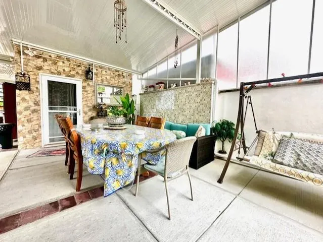 a dining room with furniture and window