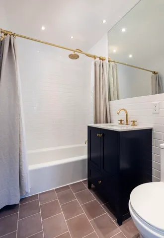 a bathroom with a sink a toilet and a bathtub