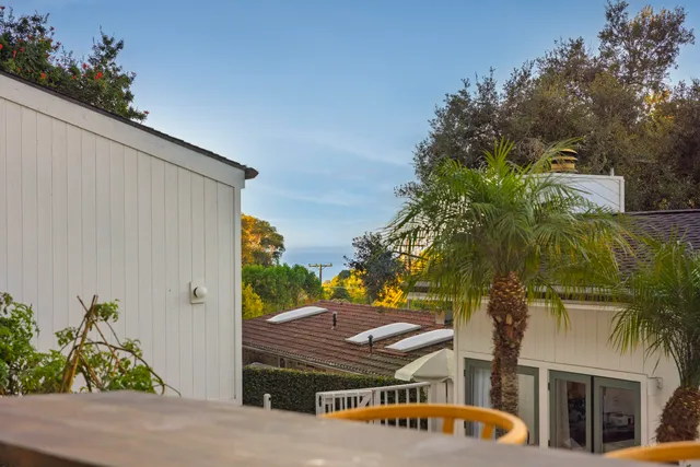 a view of a backyard with plants and a patio