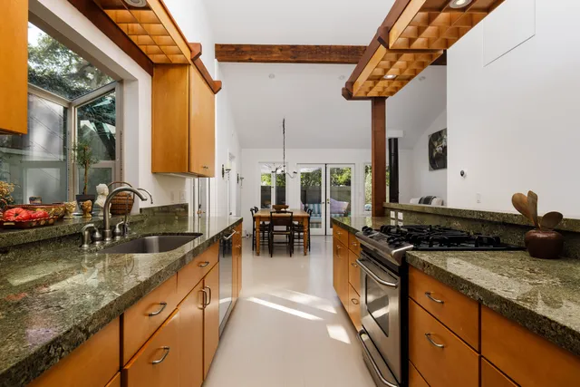 a kitchen with sink a stove and cabinets