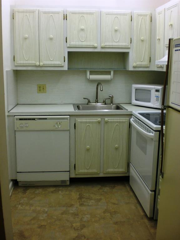 101 East McNab Road, Unit 428 Pompano Beach, FL 33060 - Photo 7 of 11 a kitchen with stainless steel appliances granite countertop a sink stove and cabinets