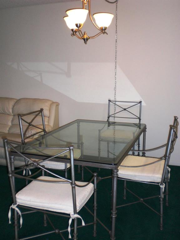 101 East McNab Road, Unit 428 Pompano Beach, FL 33060 - Photo 8 of 11 a view of a dining room with furniture and chandelier