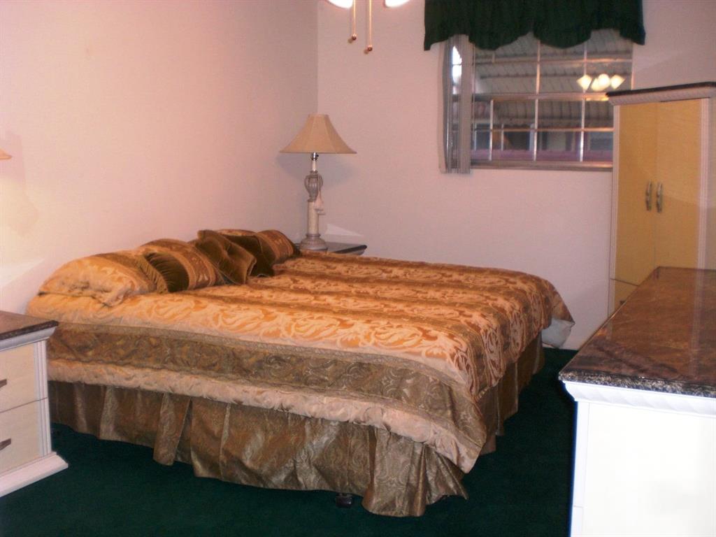 101 East McNab Road, Unit 428 Pompano Beach, FL 33060 - Photo 10 of 11 a bedroom with a bed and a window