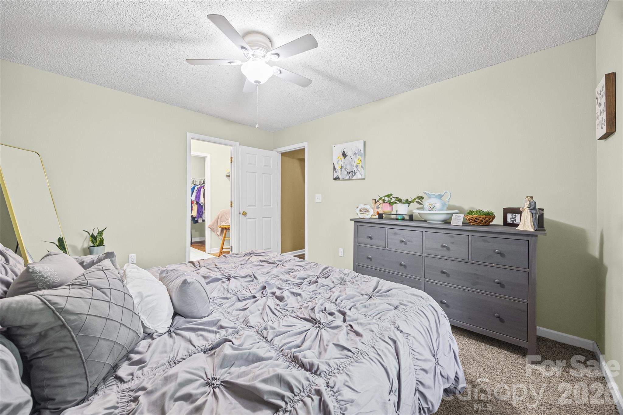 30 7th Street York, SC 29745 - Photo 20 of 29 a bedroom with a bed and a chandelier