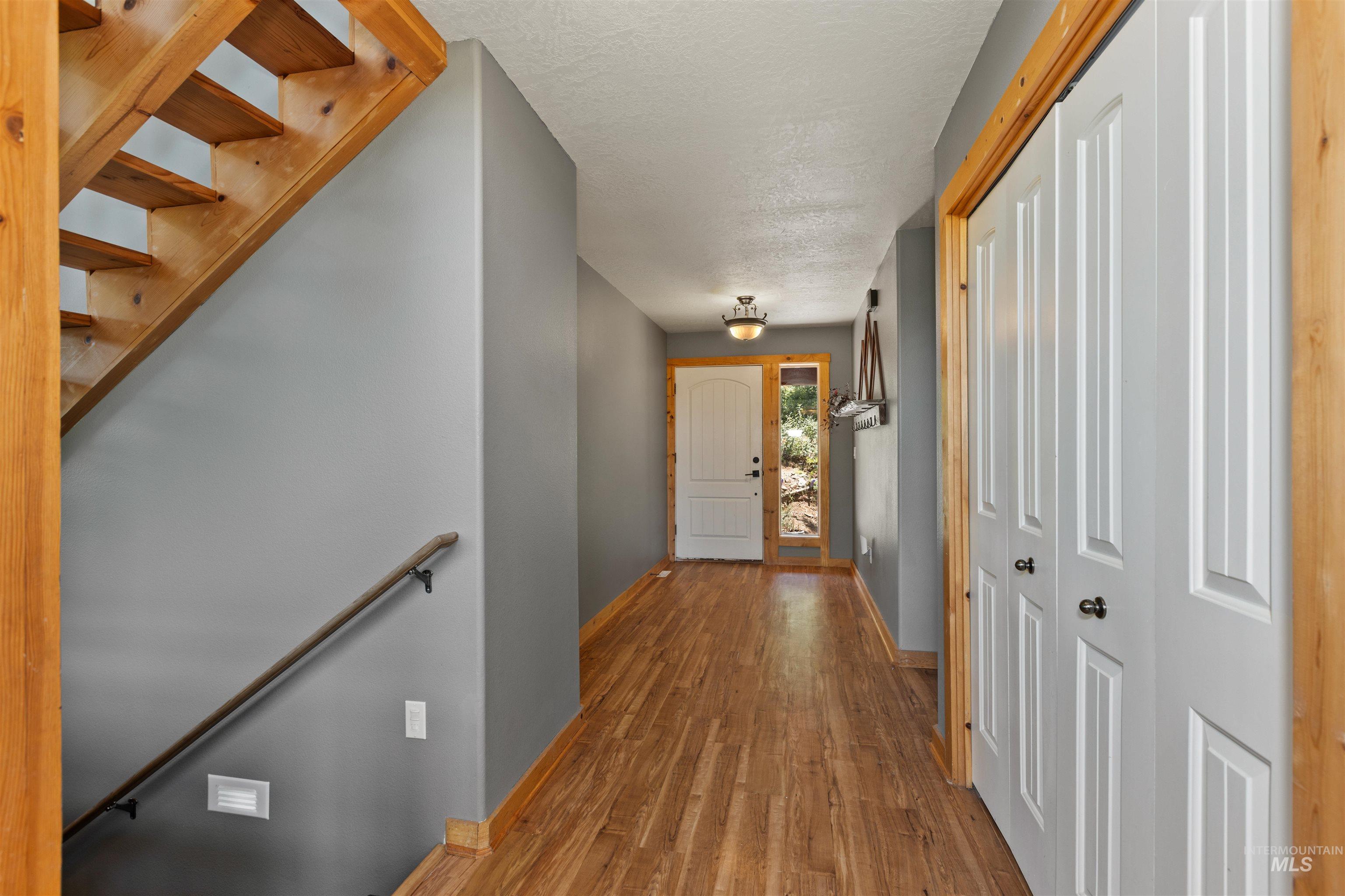 60 Highland Road Boise, ID 83716 - Photo 11 of 42 Corridor with wood finished floors and a textured ceiling