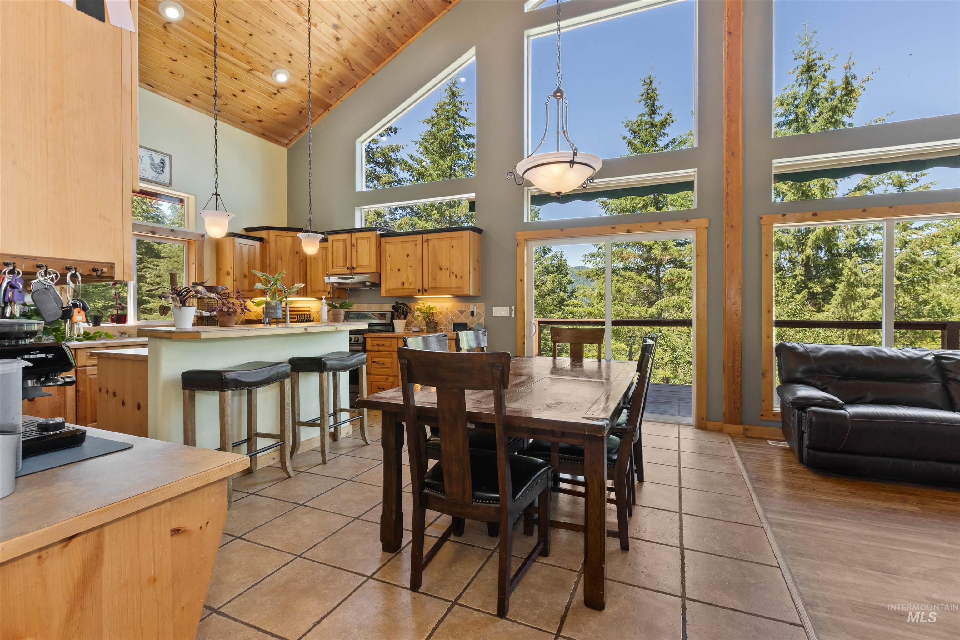 60 Highland Road Boise, ID 83716 - Photo 13 of 42 Dining space featuring wood ceiling, light tile patterned flooring, and high vaulted ceiling