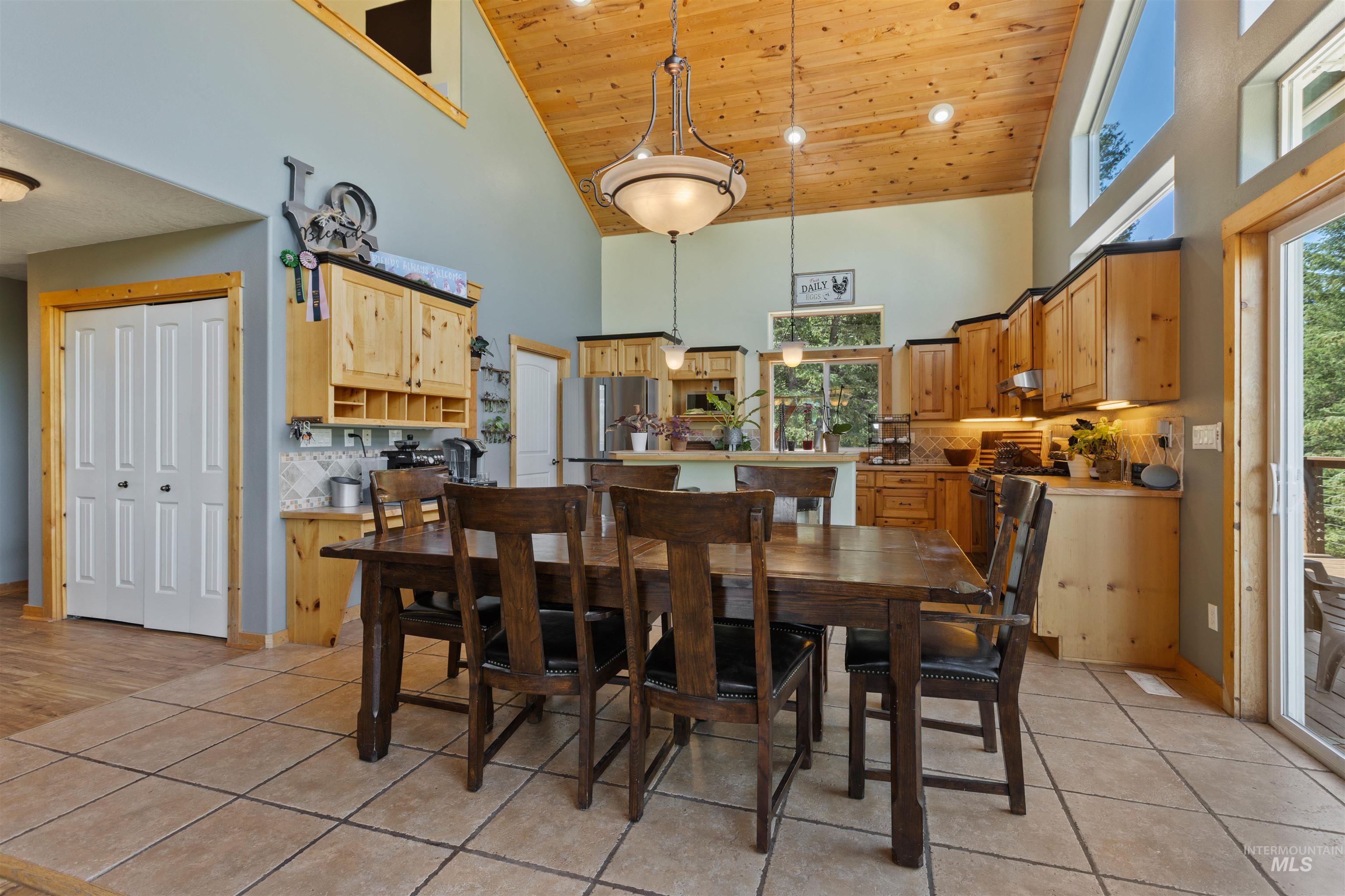 60 Highland Road Boise, ID 83716 - Photo 14 of 42 Dining area with wood ceiling, high vaulted ceiling, and light tile patterned floors