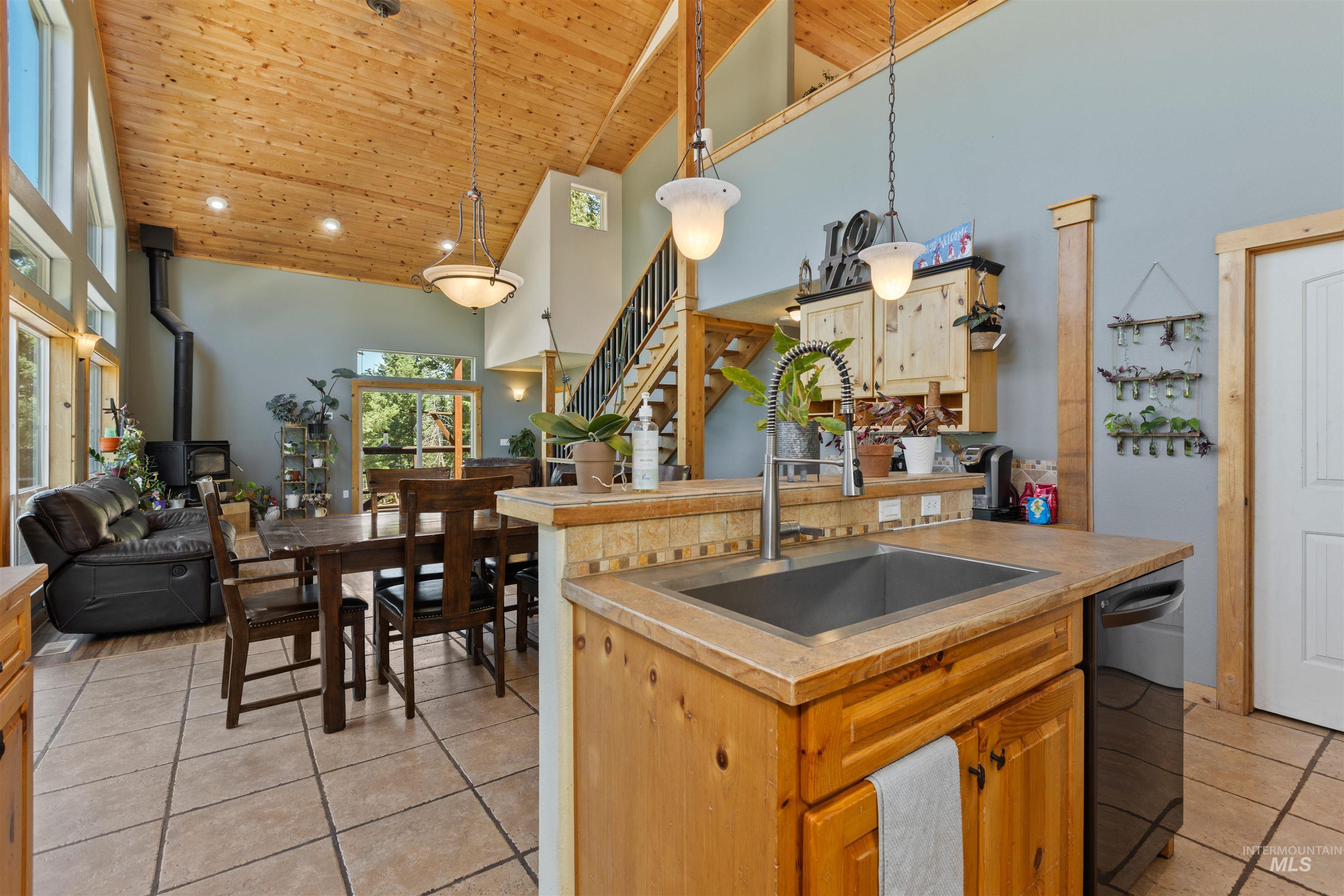 60 Highland Road Boise, ID 83716 - Photo 19 of 42 Kitchen featuring wooden ceiling, high vaulted ceiling, light tile patterned flooring, dishwasher, and hanging light fixtures
