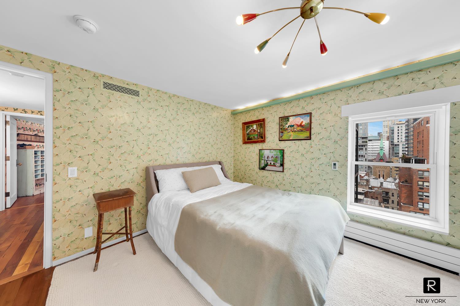 34 Gramercy Park East, Unit PHB Manhattan, NY 10003 - Photo 10 of 20 a bedroom with a bed and a chandelier