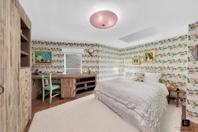 a bedroom with a bed and a chandelier