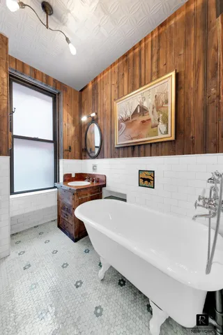 a white bath tub sitting next to a bathroom sink