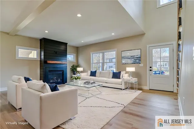 a living room with fireplace furniture and a wooden floor