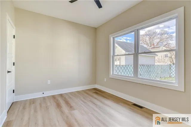 a view of an empty room and a window