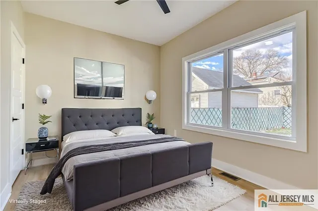 a bedroom with a large bed and a window