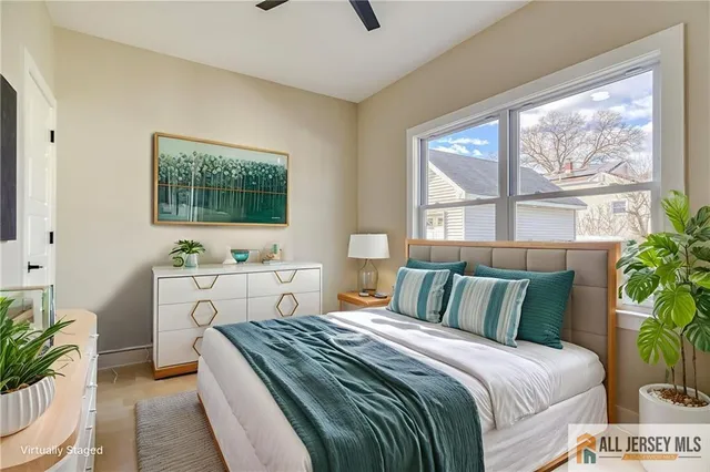 a bedroom with a large bed and a flat screen tv