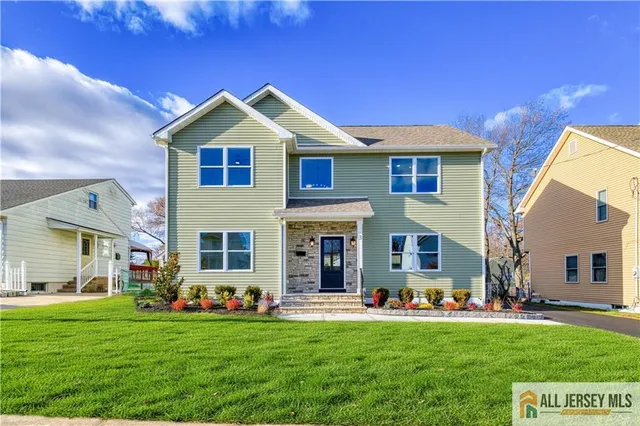 a front view of a house with patio and garden