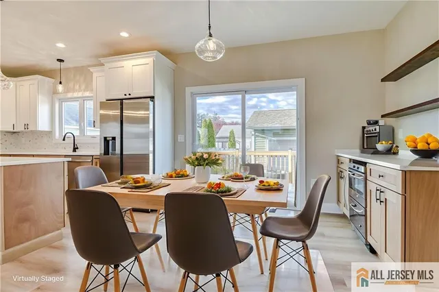 a dining room with furniture a chandelier and wooden floor