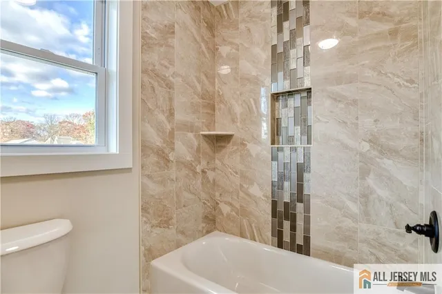 a bathroom with a shower and a sink