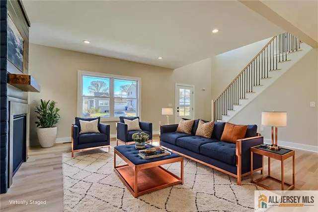 a living room with furniture fireplace and a potted plant